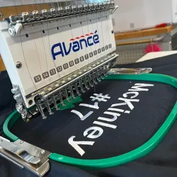 An embroidery machine stitching a design into a garment